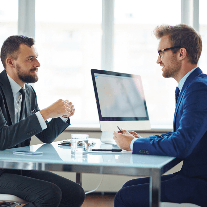 business professionals speaking at a desk