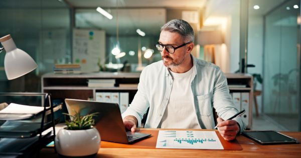 Older man sitting in an office working