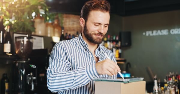 Man in Coffee Shop, using his tablet