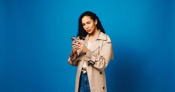 Woman staring at her phone in confusion