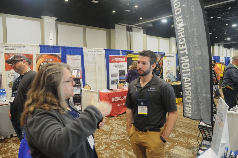 James Haywood speaking to another attendee at the PSATS conference