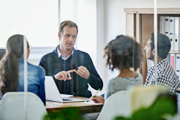 4 people sitting together in a meeting