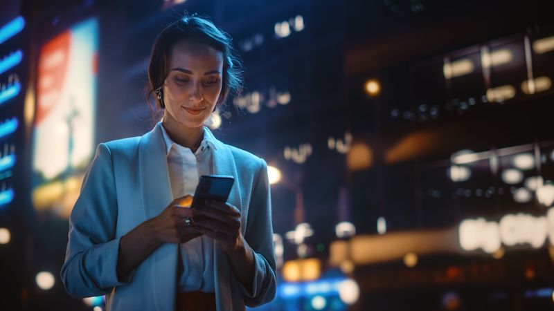 woman using a cellphone in a city environment