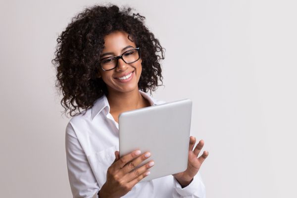 A woman browsing the internet on her tablet