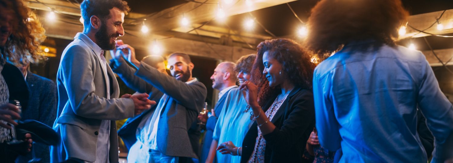 professionally dressed people dancing together