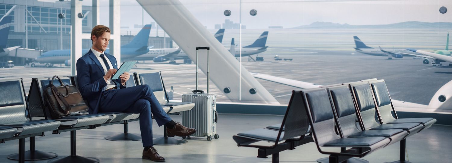 businessman using a tablet at an airport