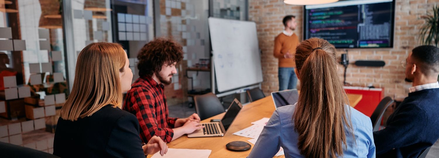 it employees discussing code at a meeting