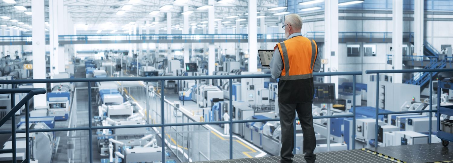 facility manager overlooking industrial processes