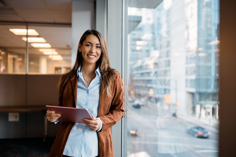 happy businesswoman holding a tablet