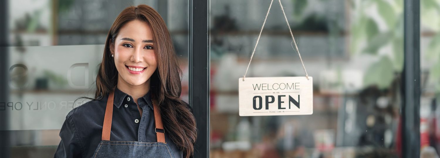 woman standing in front of an open business