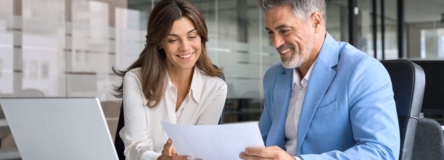 two business professionals reviewing reports together