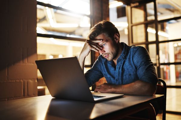 A computer user frustrated after falling for a phishing scam