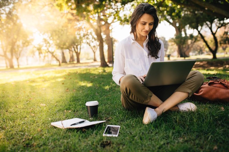 woman working outdoors on a laptop