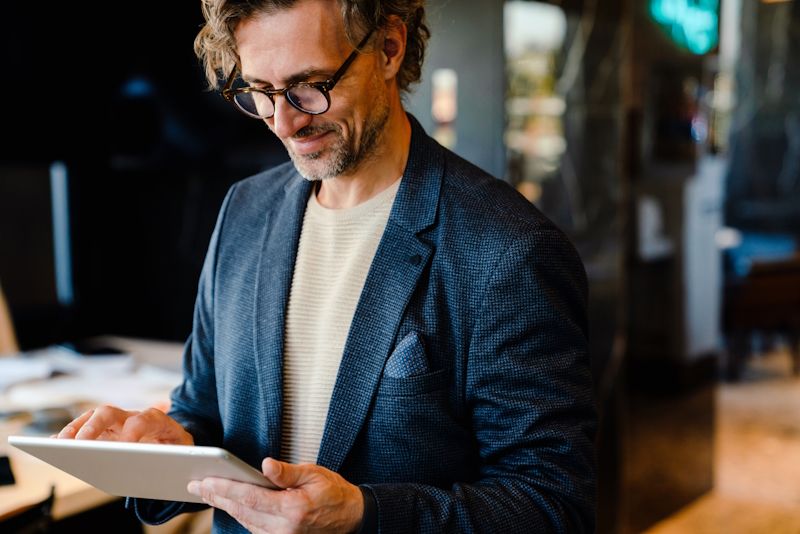 professional in a suit using a tablet device