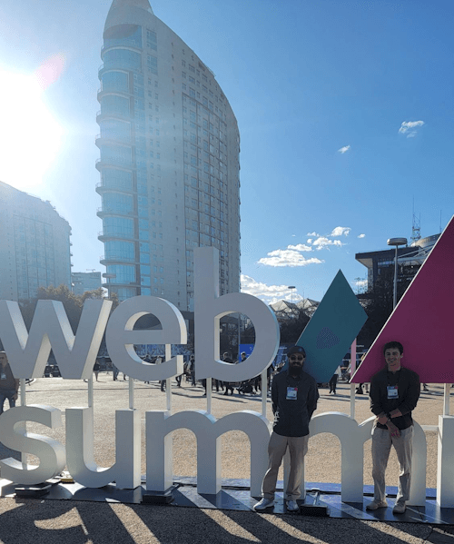 adam and eric of intrada sitting with a web summit sign