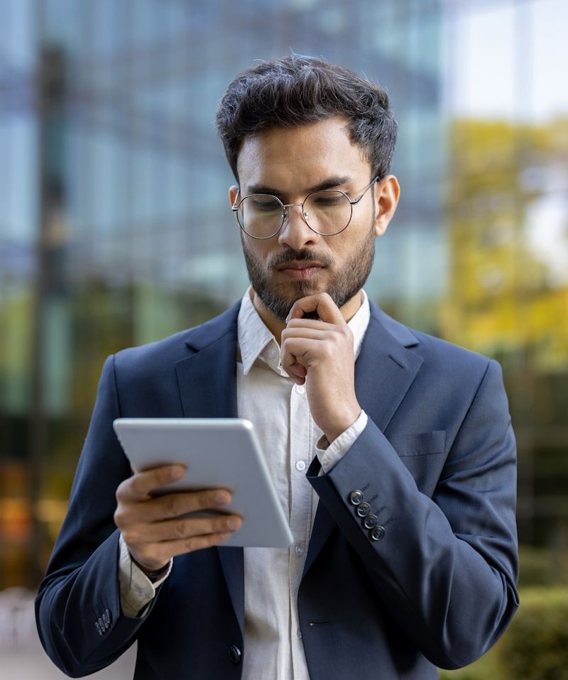 businessman focused on reading content on his tablet device