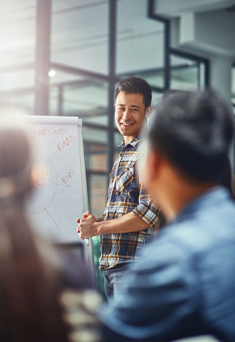 man presenting information about a project to his team