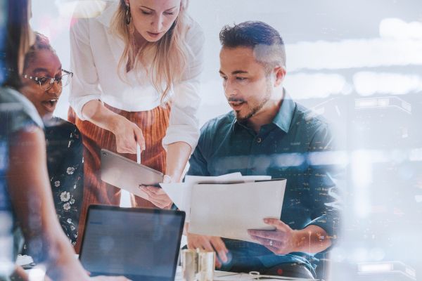 Businesspeople collaborating to write a document